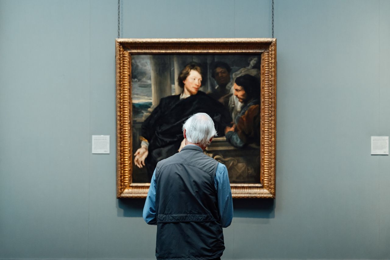 Visitors using a digital audio guide in a temporary museum exhibition